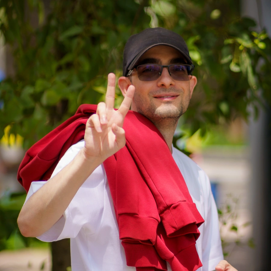 Yuri, one of our team members, smiles and holds up the peace sign