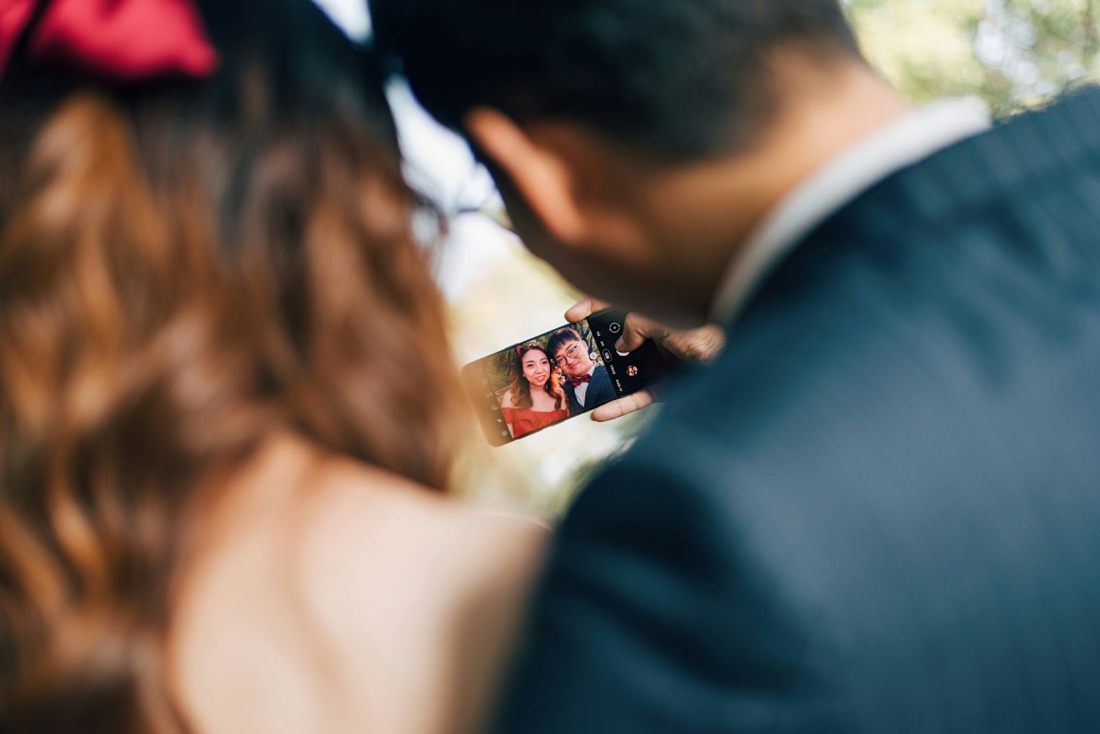 couple taking a photo at a wedding