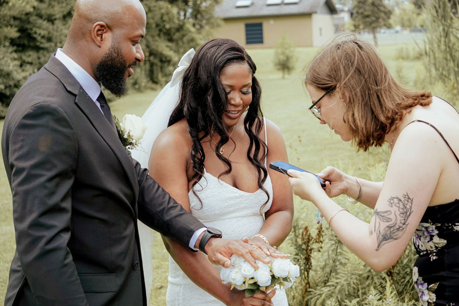 Wedding couple taking a photo of their rings
