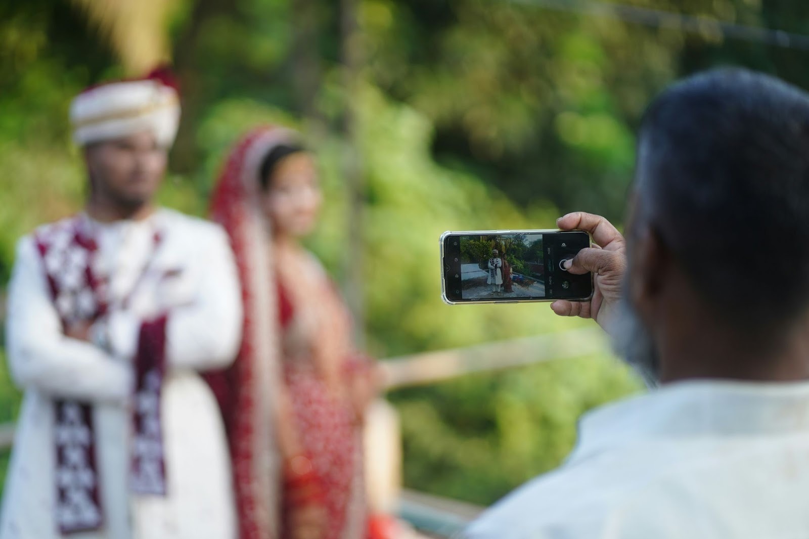 Taking a photo of a bride and groom with an iPhone