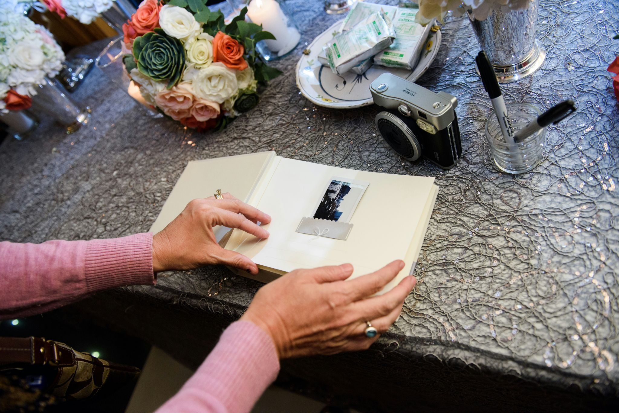 Wedding guest placing an image in a guest book
