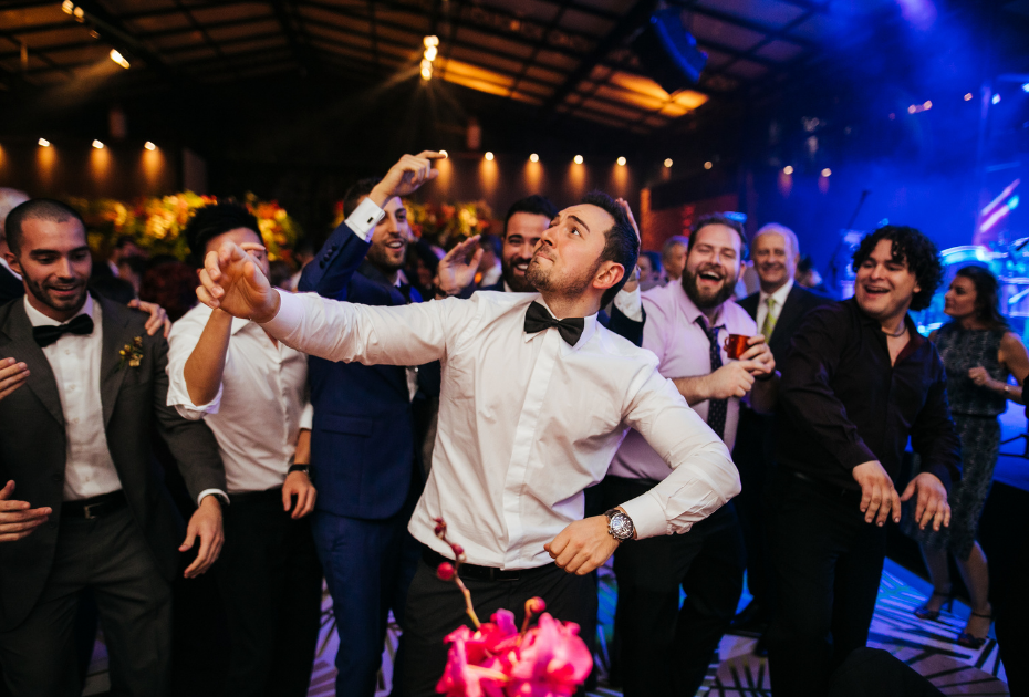 Wedding guest photo ideas of the groom and guests dancing at a wedding.