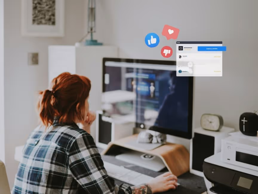 girl working on computer at home office. client reviews on screen. like, dislike and love social reaction buttons floating