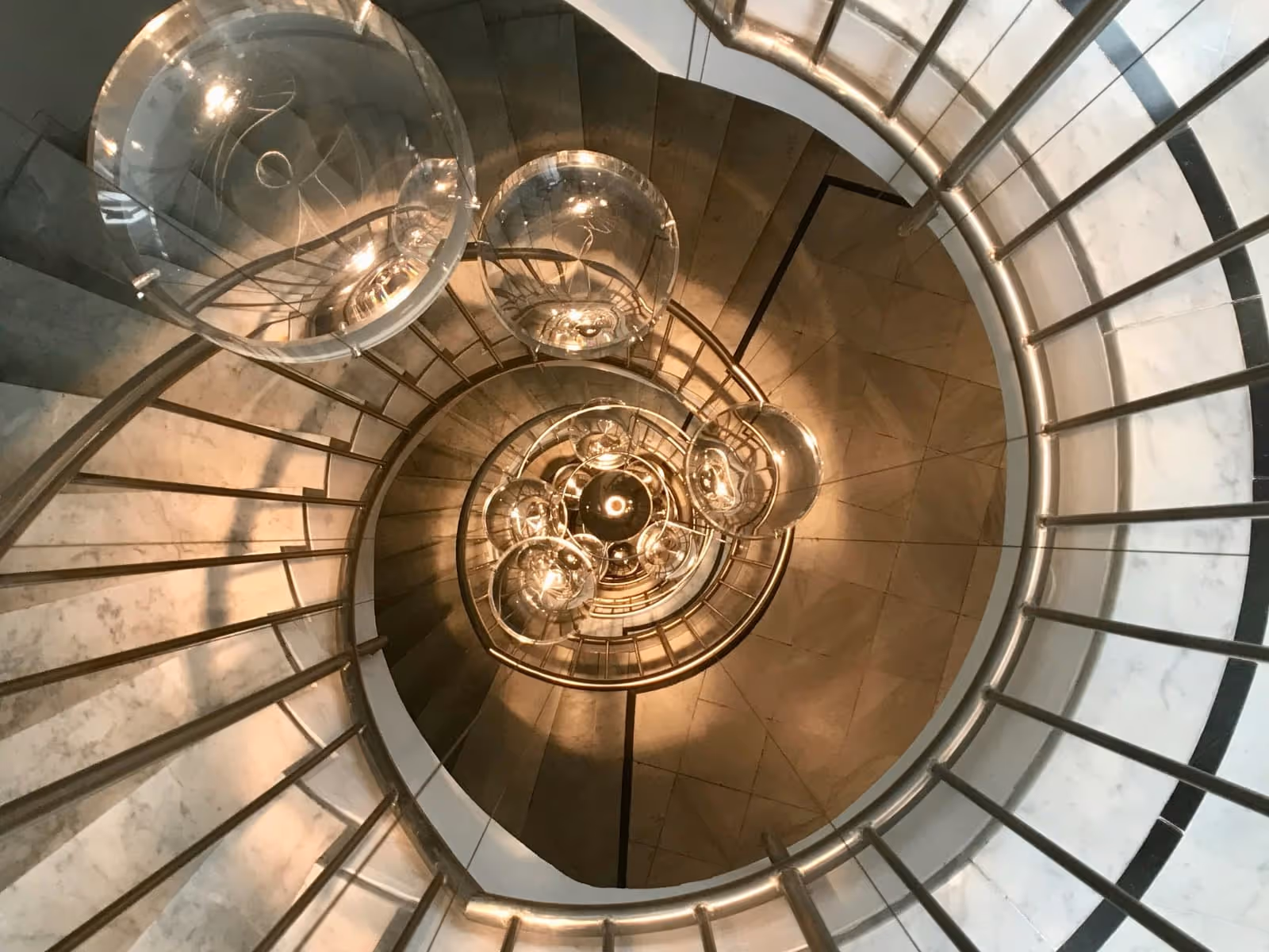 spiral staircase with bubble like light fixtures in the middle