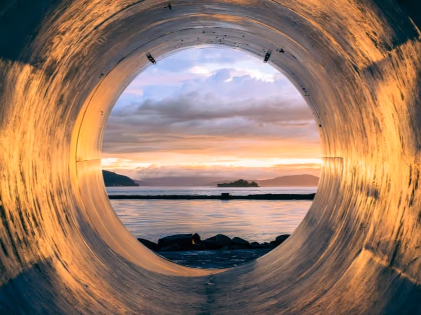 Looking through a circle into the ocean view at sunset