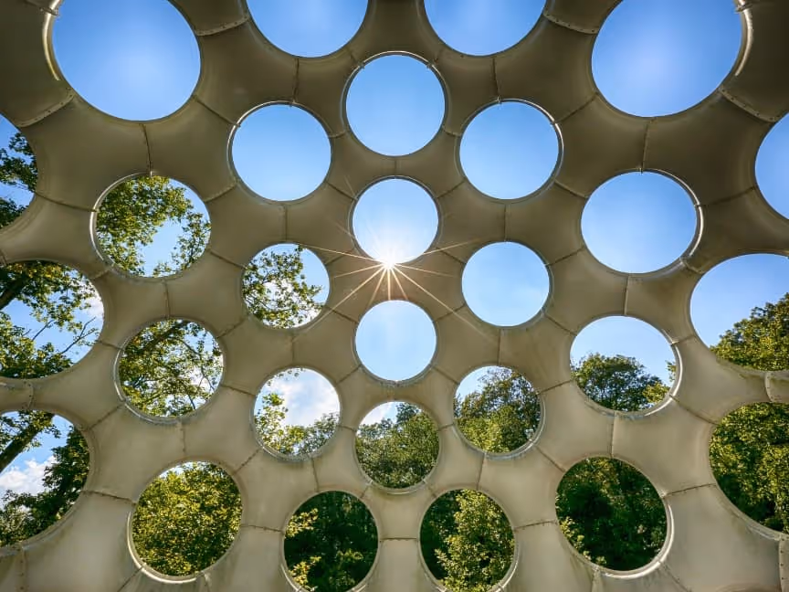 Sunburst shining through the holes in Buckminster Fuller's Geodesic creation at Crystal Bridges.