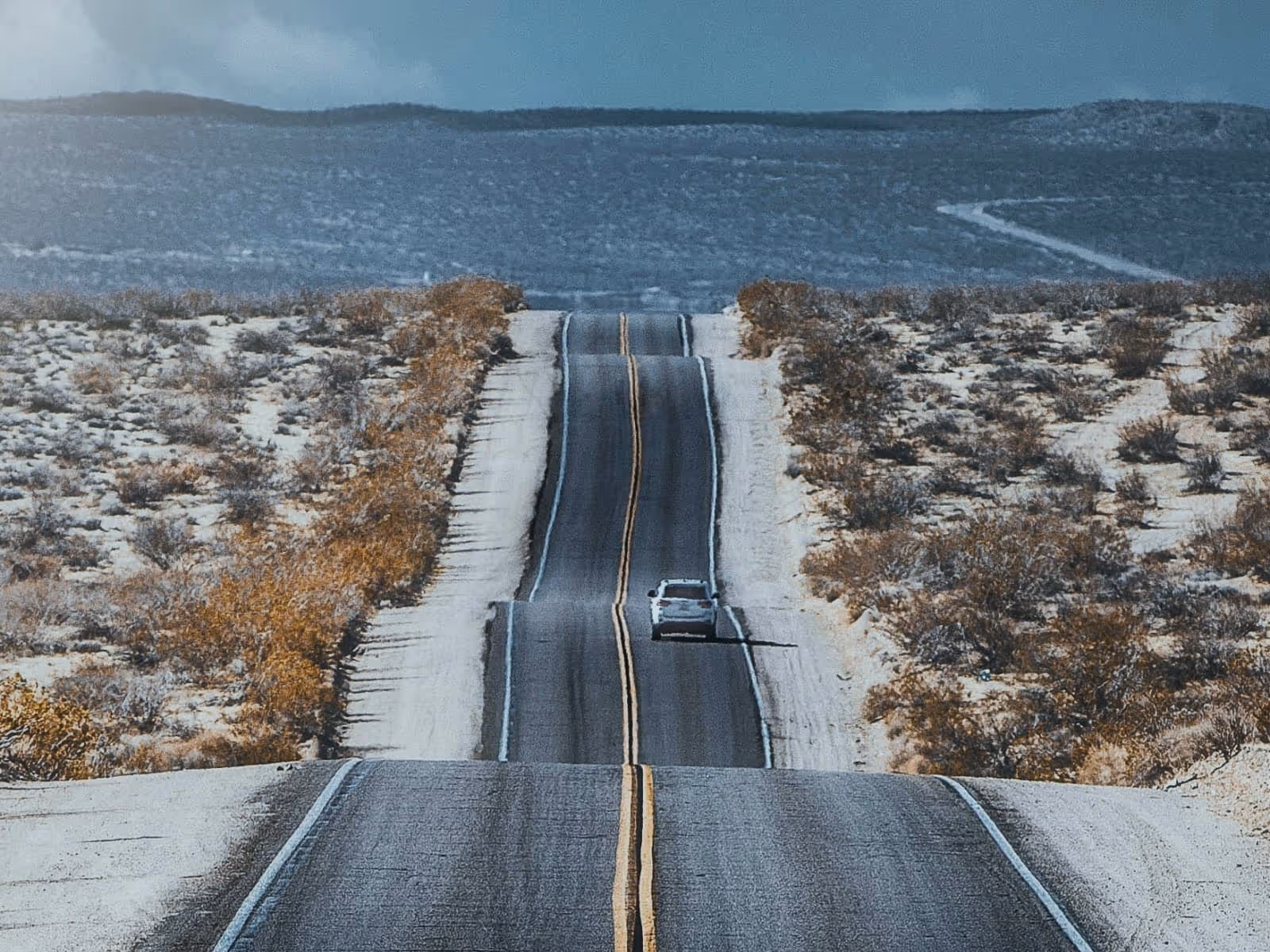 car driving down long road