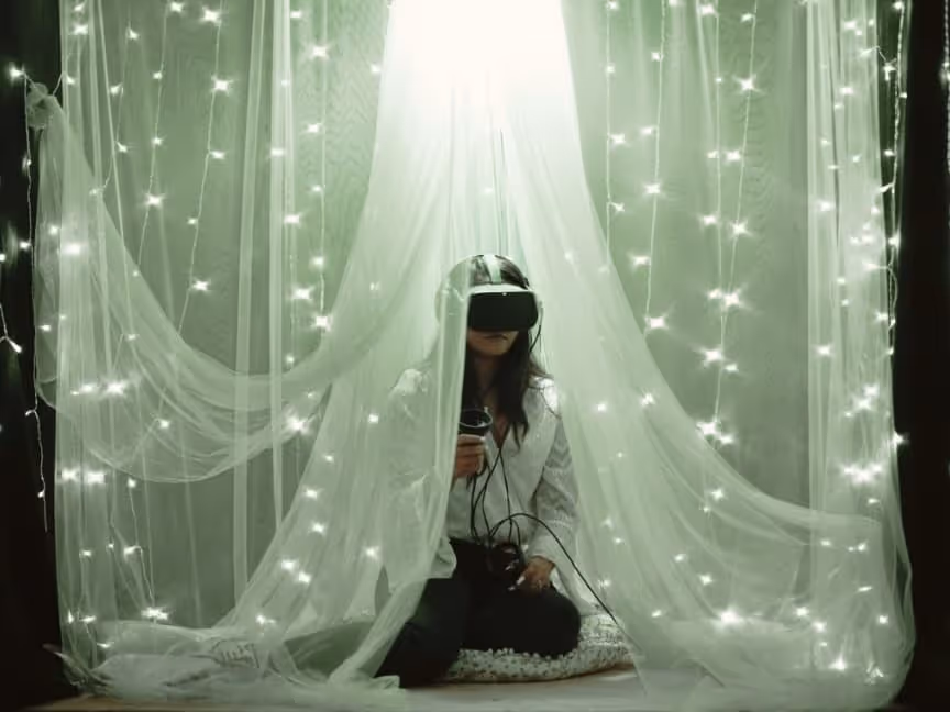 women sitting on the floor. fairy lights. virtual reality goggles.