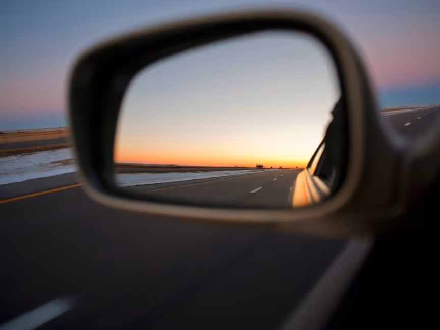 review mirror looking sunset