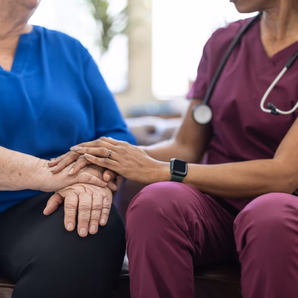 nurse taking care of elderly women patient wolding hands