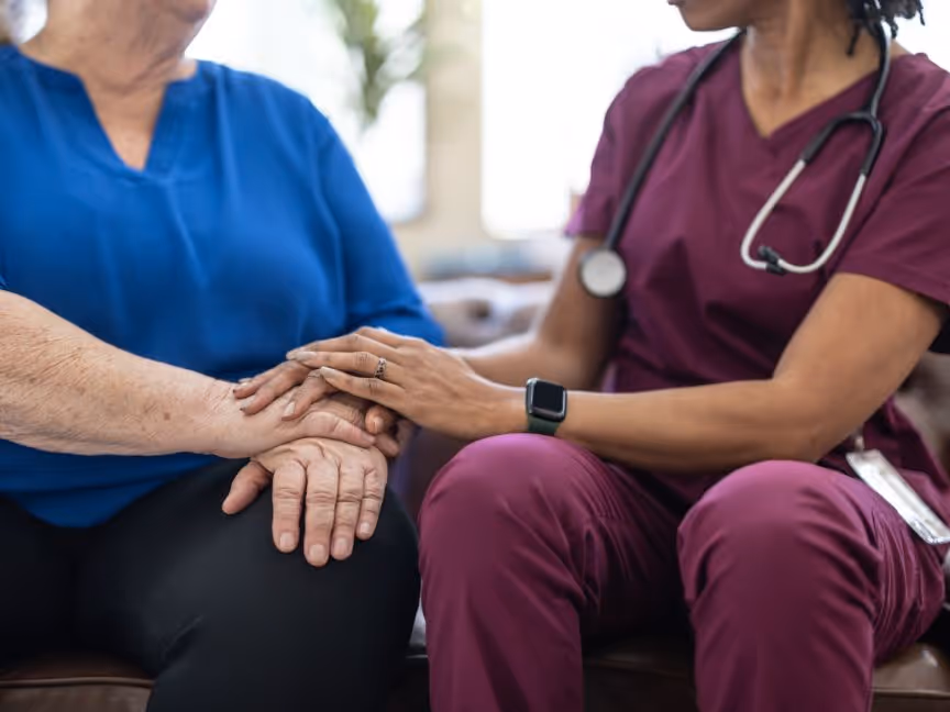 nurse taking care of elderly women patient wolding hands