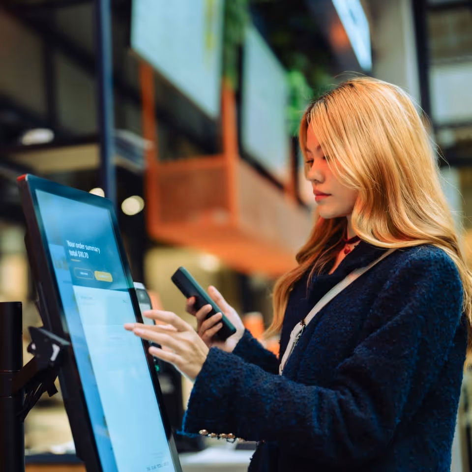women wearing orange sweater working on laptop