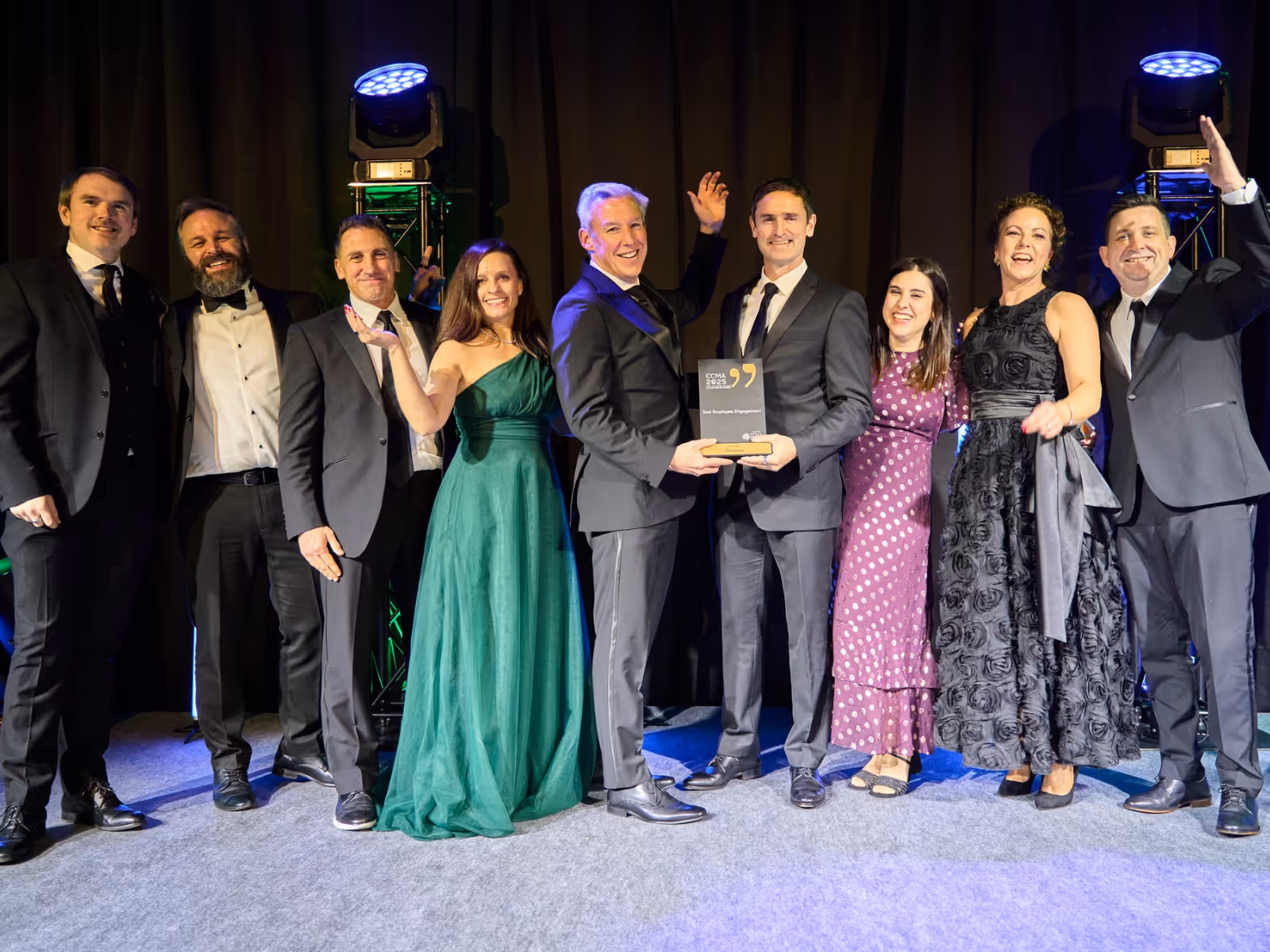 Otonomee team on stage lined up receiving an award