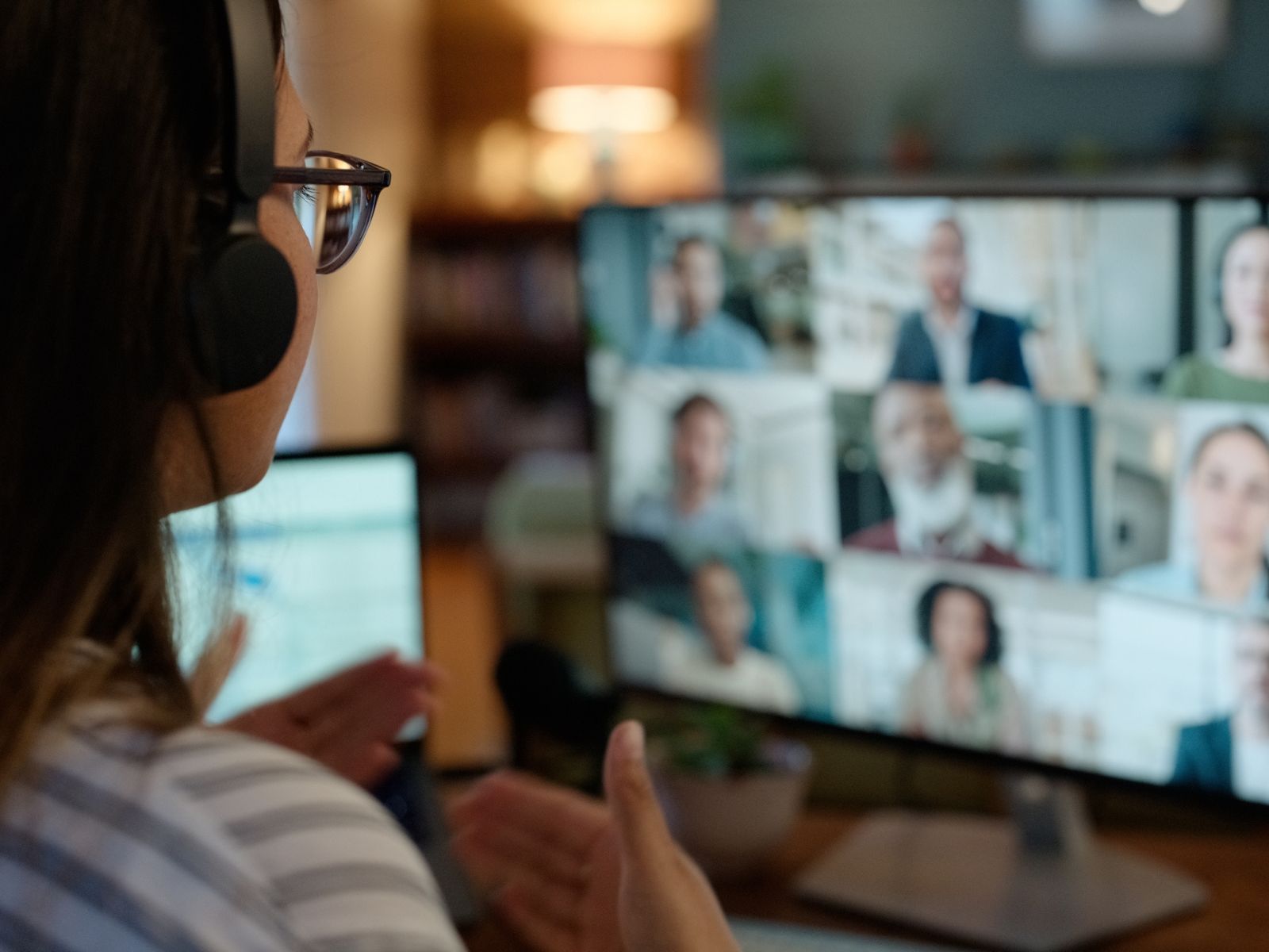 Woman working from home in an online meeting with people