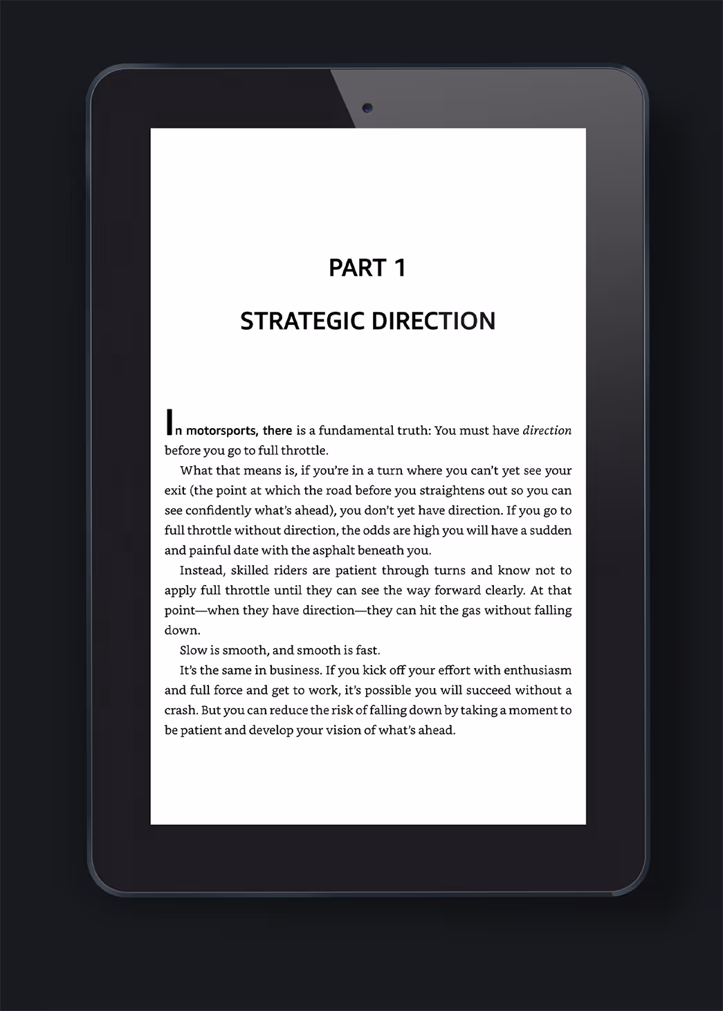 An e-reader displaying a text page titled 'PART 1 STRATEGIC DIRECTION.' The content discusses the need for direction in motorsports, emphasizing the importance of clarity and effort in reaching goals, related to publisher book design services.