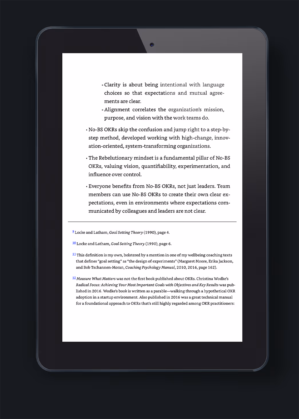 A digital tablet displaying text about clarity in communication and expectations within organizations. The content emphasizes the role of No-80-OKRs in facilitating alignment and transparency in team efforts. Relevant for discussions on publisher interior book design and ongoing book design services.