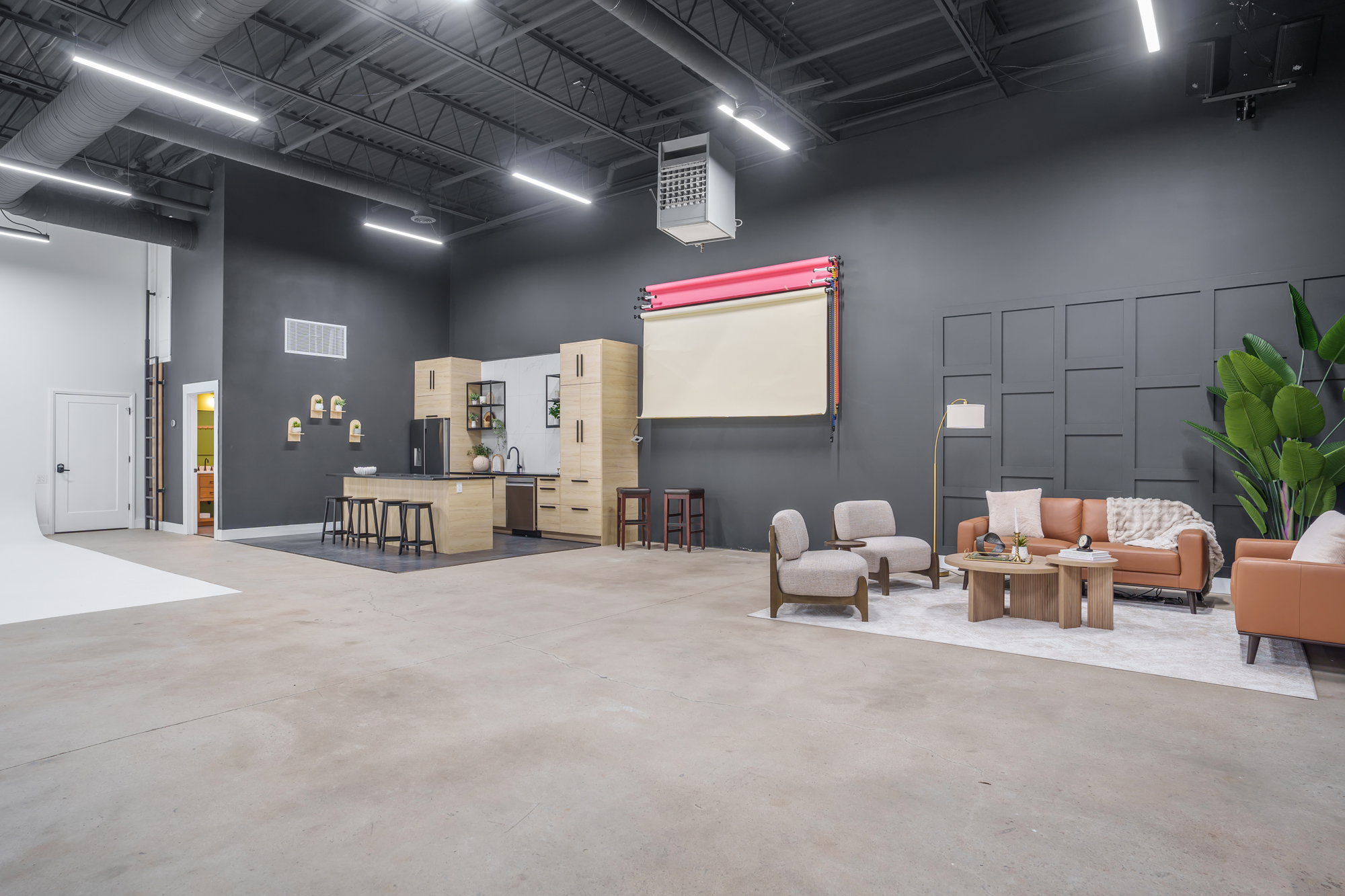 The Halo Lounge, a bright lounge set with a white sofa, grey swivel chairs and a round coffee table