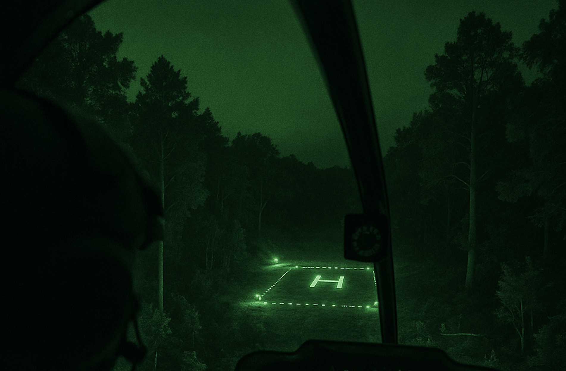 A pilots view of a night landing site for a helicopter in the green glow of night vision goggles