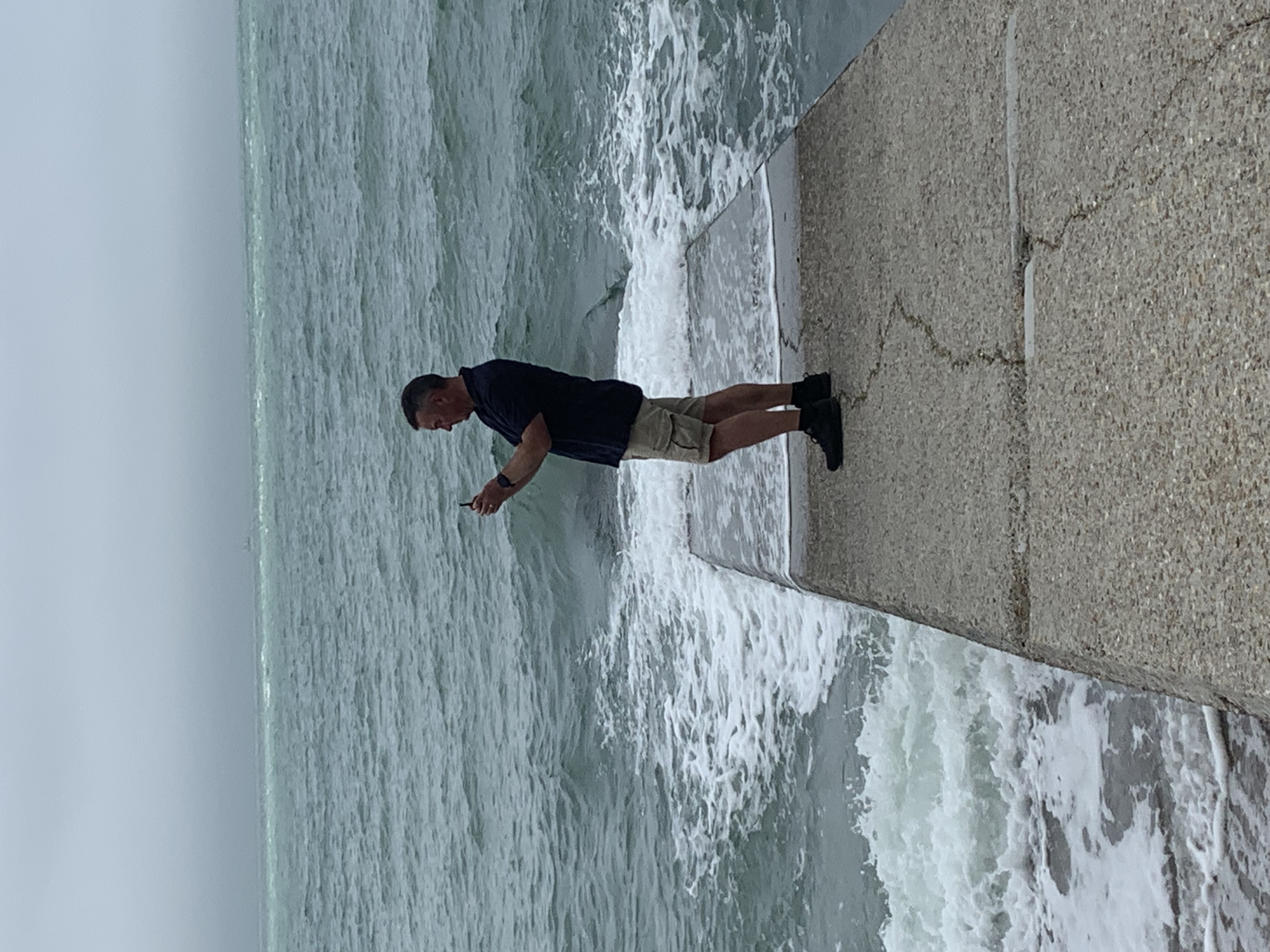 The author at the end of a ramp towards the sea looking at their phone wondering if this is the right direction