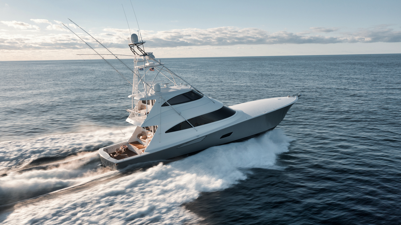 Viking Fishing Charter Boat with enclosed bridge running in the ocean.
