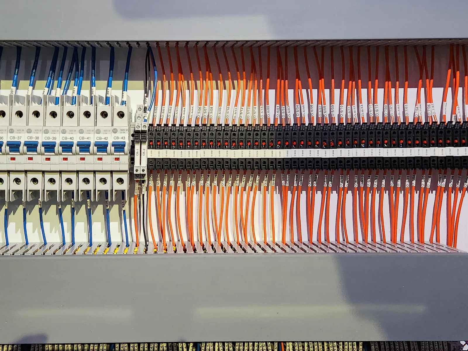 Terminal strips after rebuild, with conductors landed in ordered rows and run into duct.