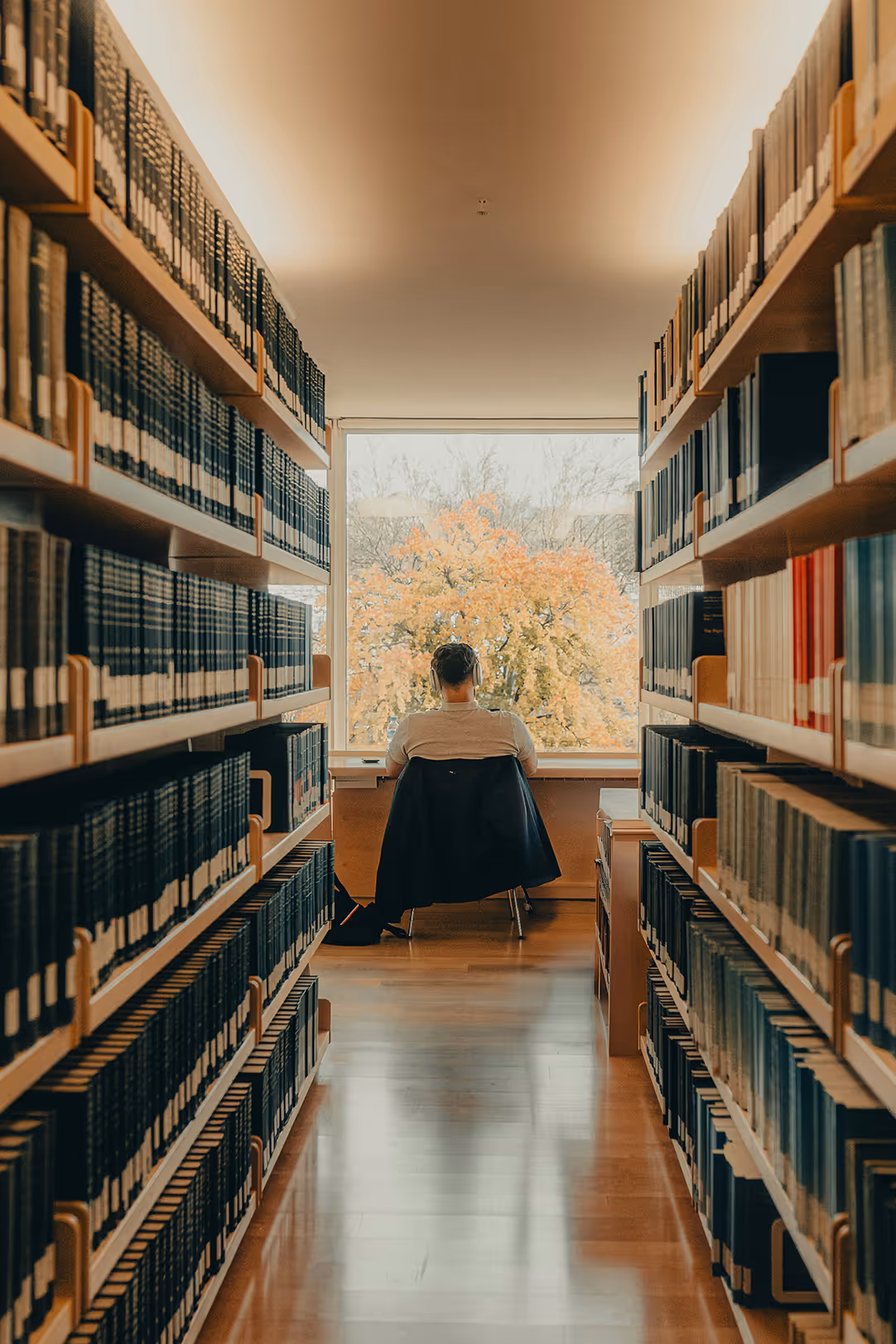 A person sitting quietly in a library.