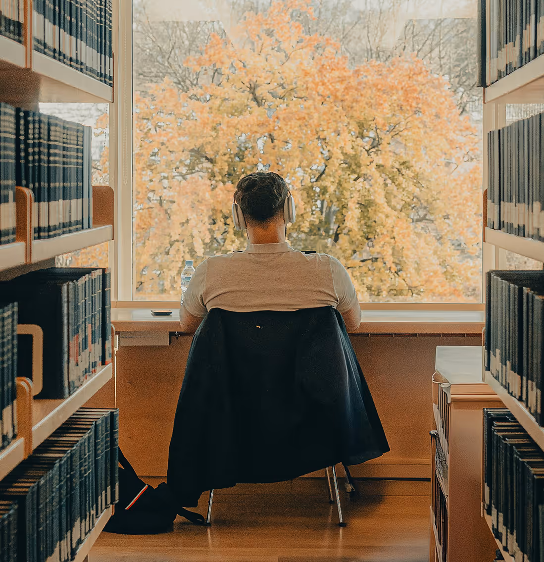A person sitting quietly in a library.