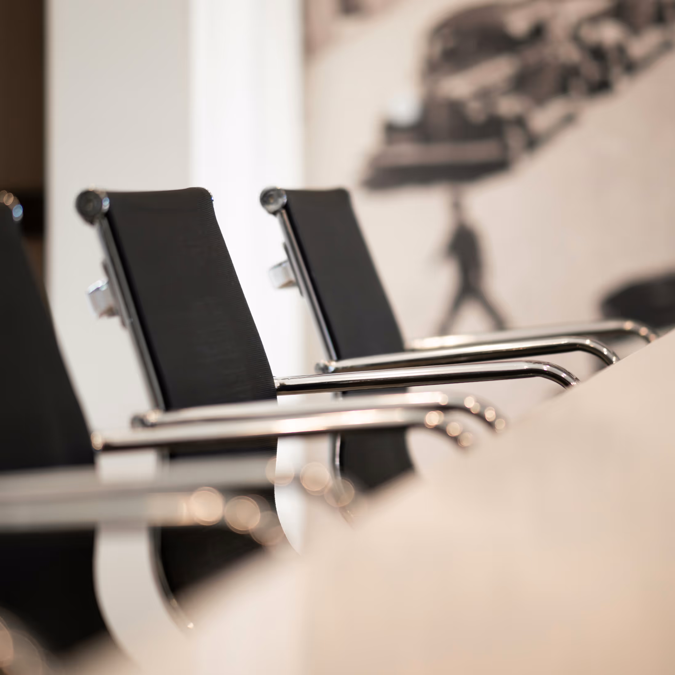 Empty chairs at a meeting table.
