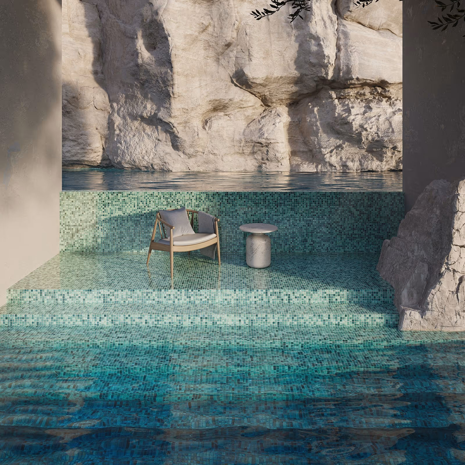 A modern outdoor pool area with turquoise mosaic tiles, featuring a wooden chair with cushions and a small round white table, set against a rocky cliff backdrop.