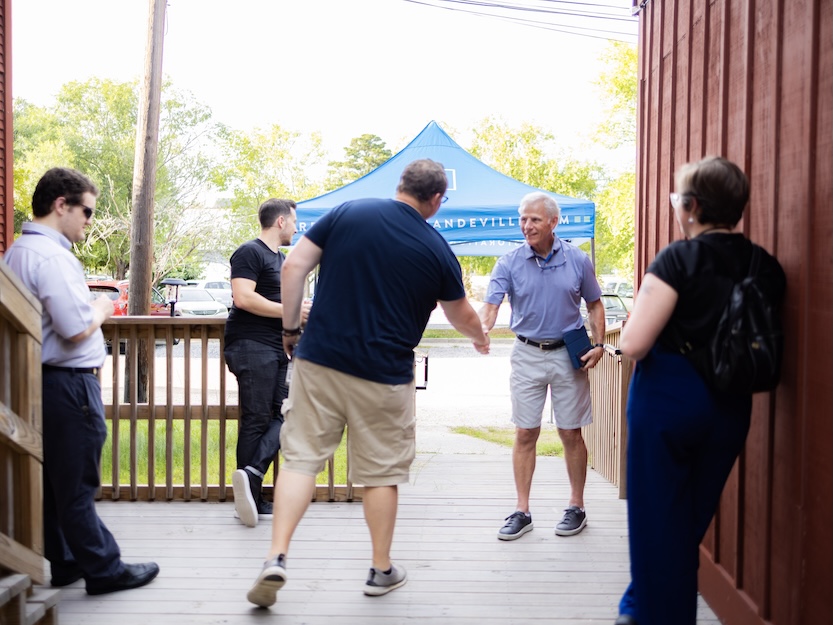 People shaking hands outside the North Star Theatre attending Restoration Community Church