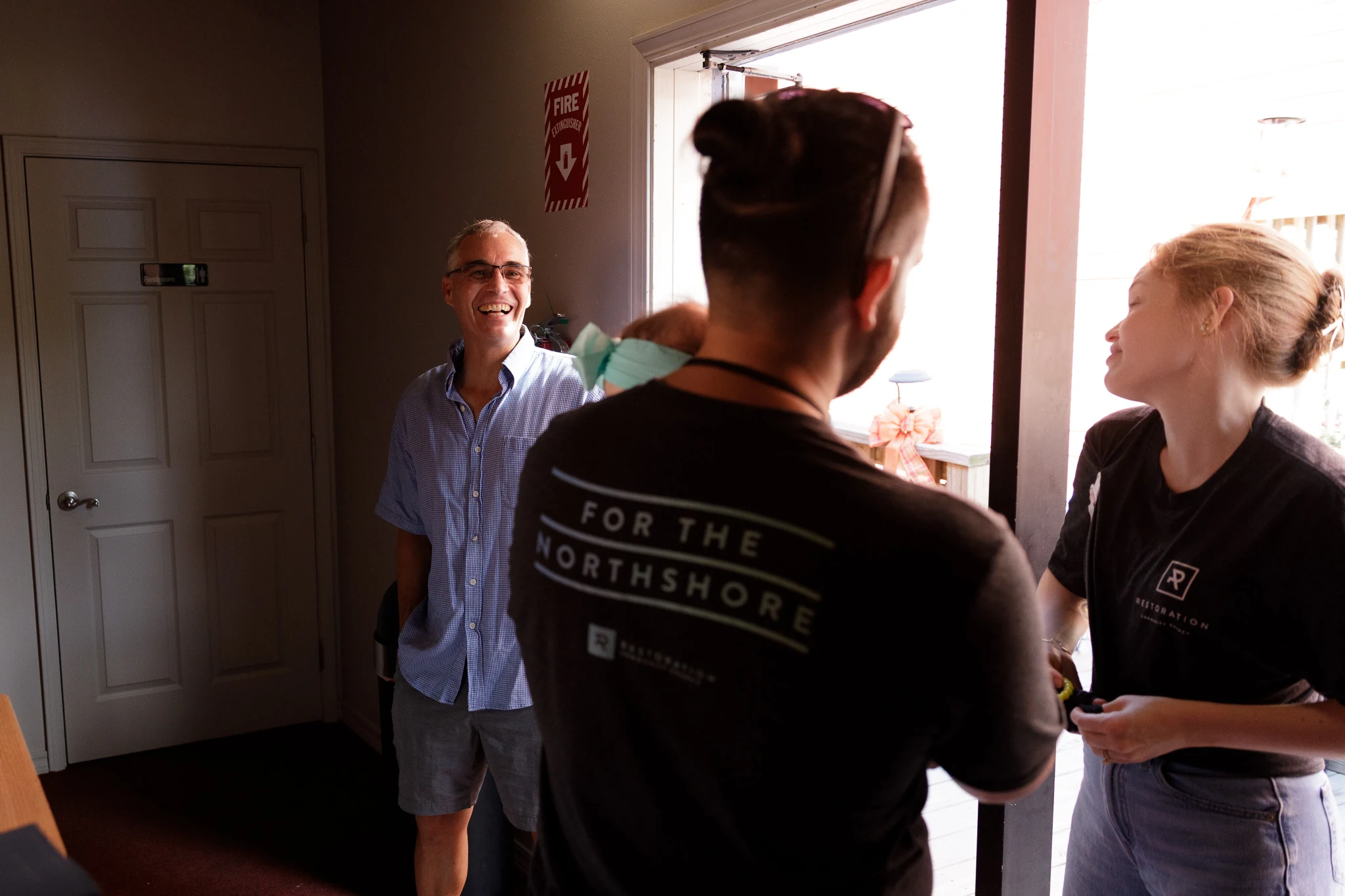 Friends greeting one another at Restoration
