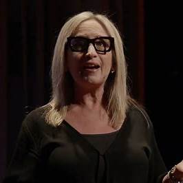 Sandy Abrams, entrepreneur, author, and breathwork expert, speaking on stage."