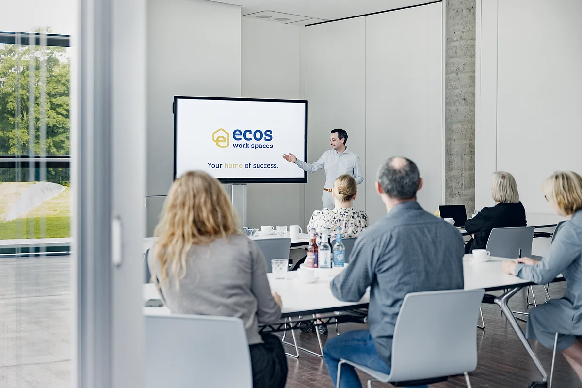 Conference room with a presentation on a large screen at ecos work spaces in the Berliner Bogen, Hamburg