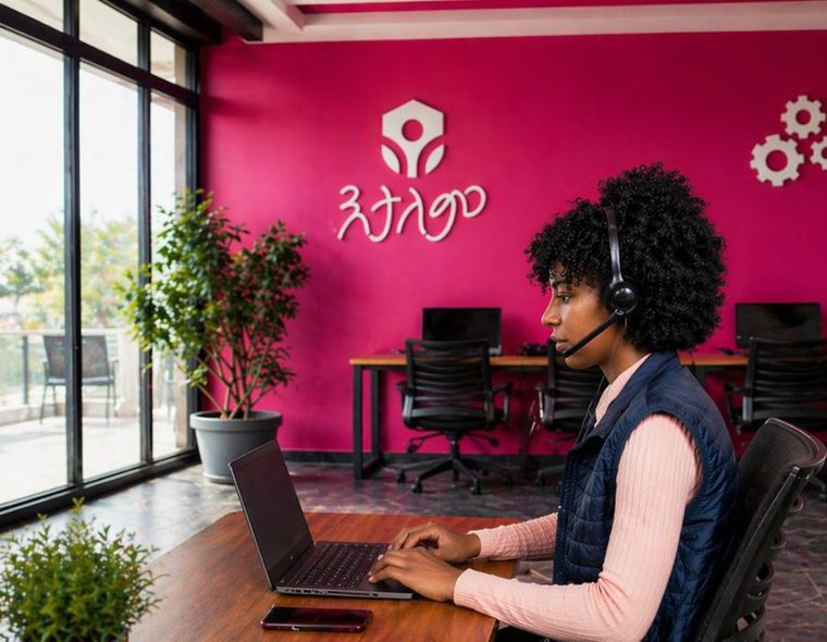 An Etalem service coordinator at her desk in the Etalem office, wearing a headset