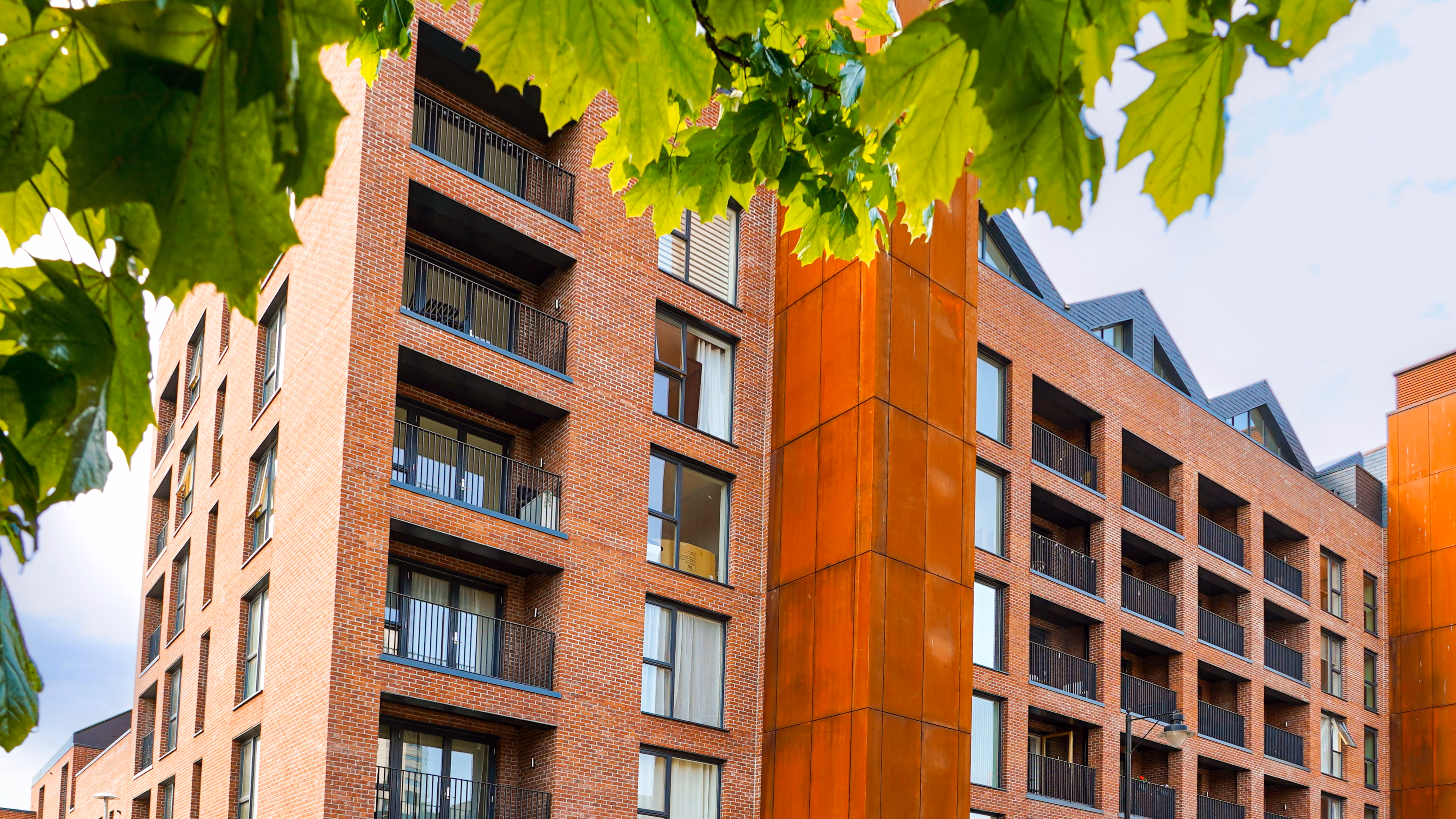 image of completed, red brick residential building 