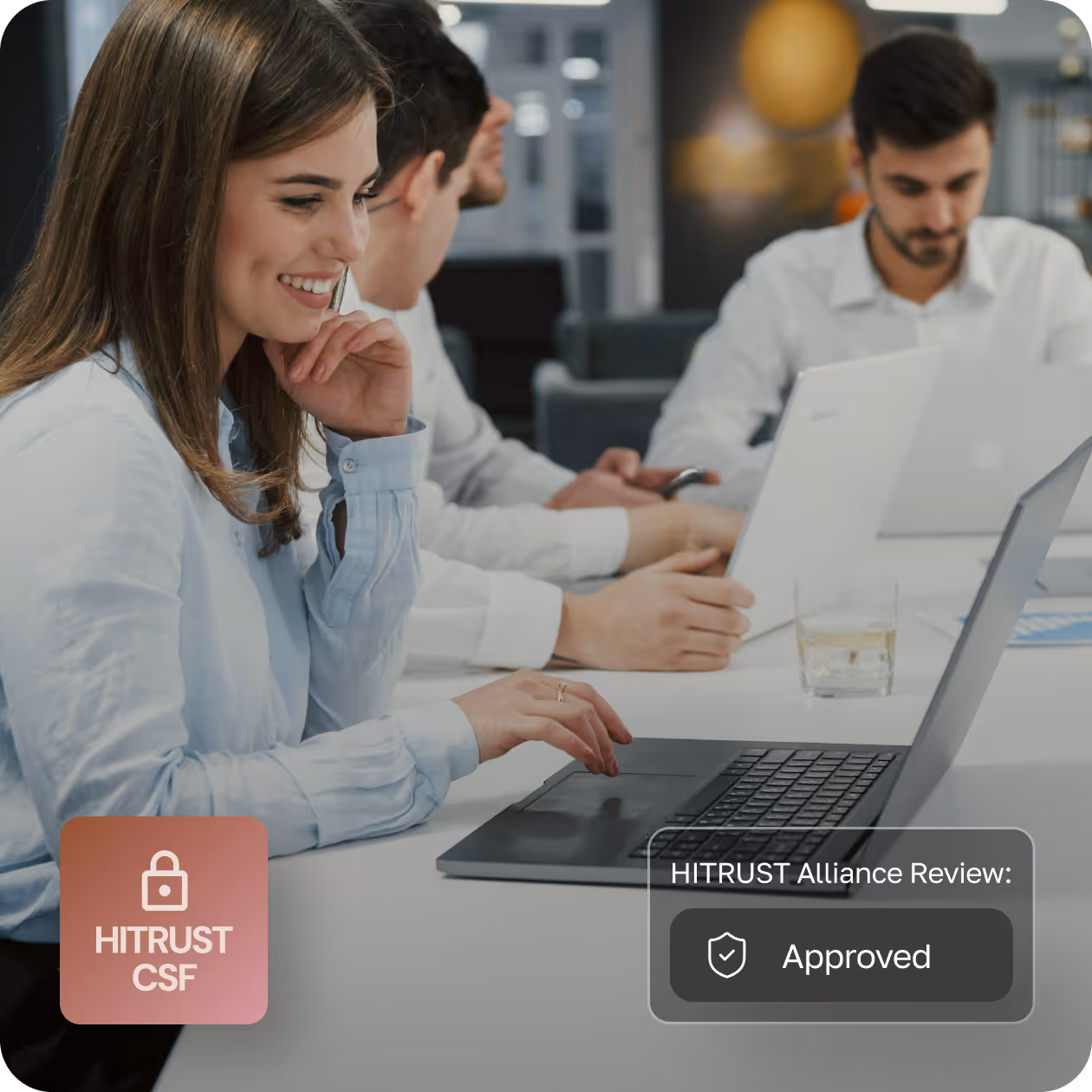 Person in a white coat typing on a laptop keyboard with a pen in hand, on-screen text shows 'Third-Party Assessor: Engaged' and a HIPAA Compliance badge.