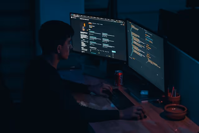 Why does ISO 27001 certification matter as cybersecurity professional sits behinds his computer monitors