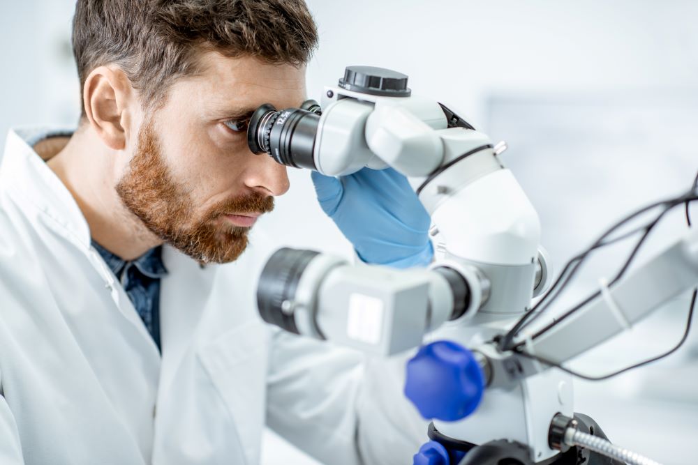 Scientist using a microscope