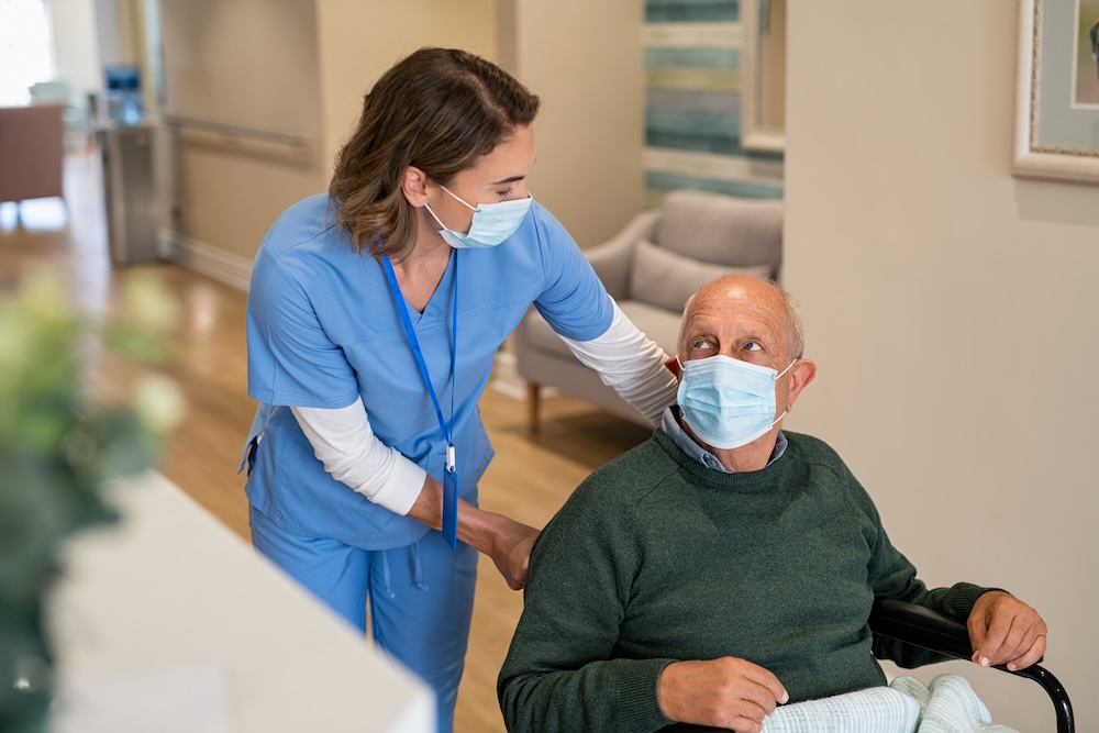 nurse working with man with complex care needs 