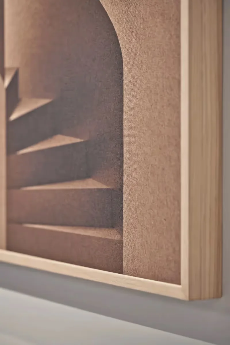Akuart Imagine acoustic art panel in a natural oak frame hanging on a white wall in a serene modern lounge
