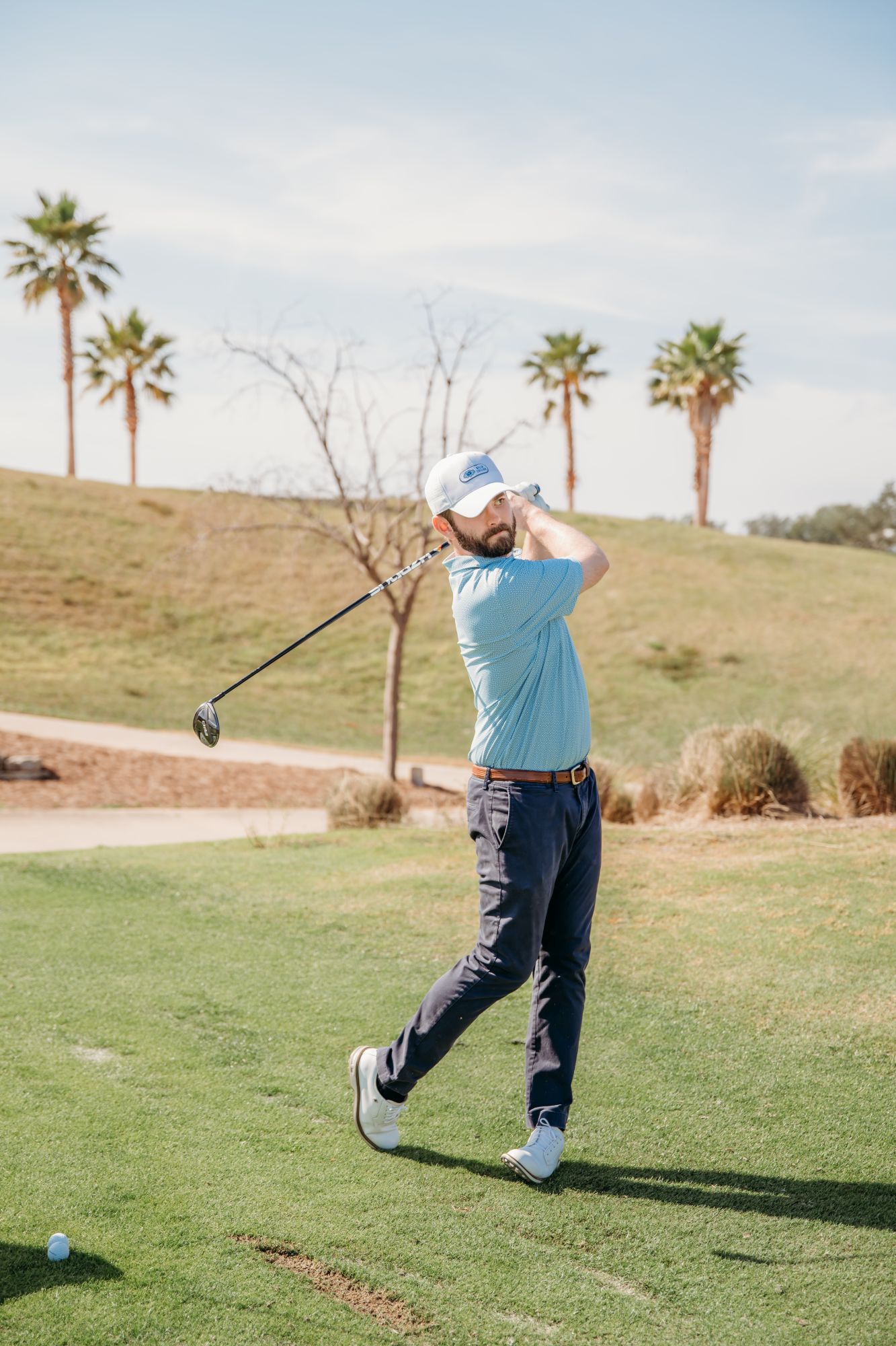 Spencer Schar taking a swing on the golf course.