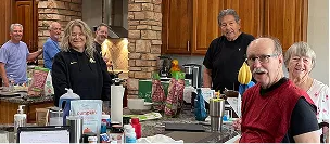 The Ironpeak Southwest team and guests make toffee for the holiday season in a large kitchen.