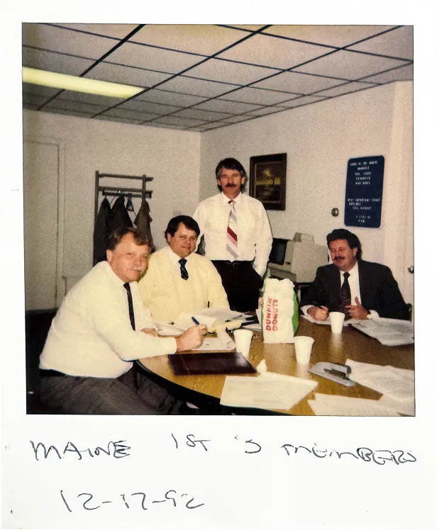 Polaroid of Iroquois’ Greg Chiapuso sharing doughnuts with the first three Iroquois Members in Maine in 1992.