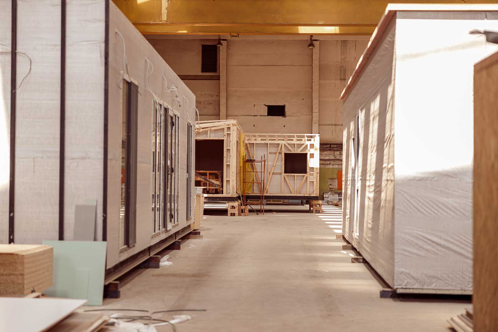 Modular building sections under assembly inside a factory