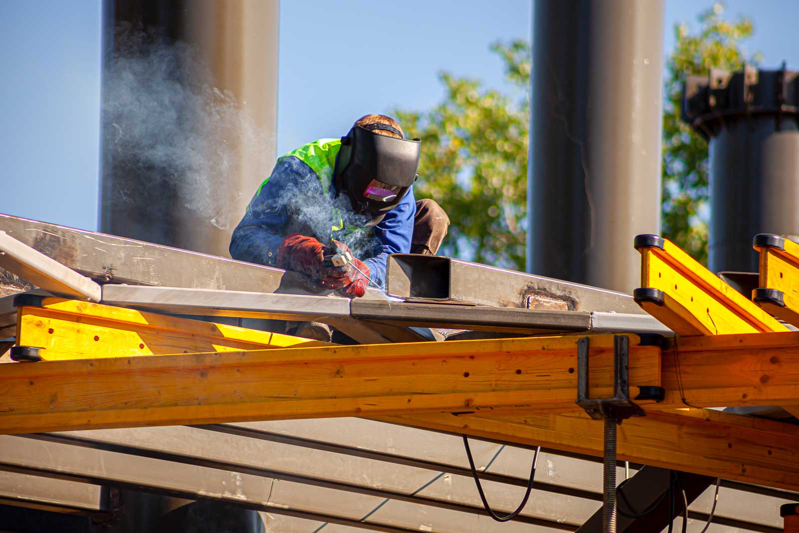 Welder fabricating a steel beam in the shop