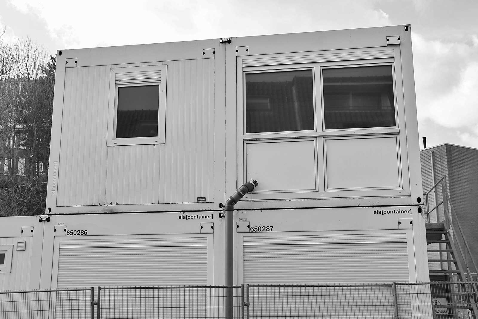 Modular building exterior with windows and an exterior stairway
