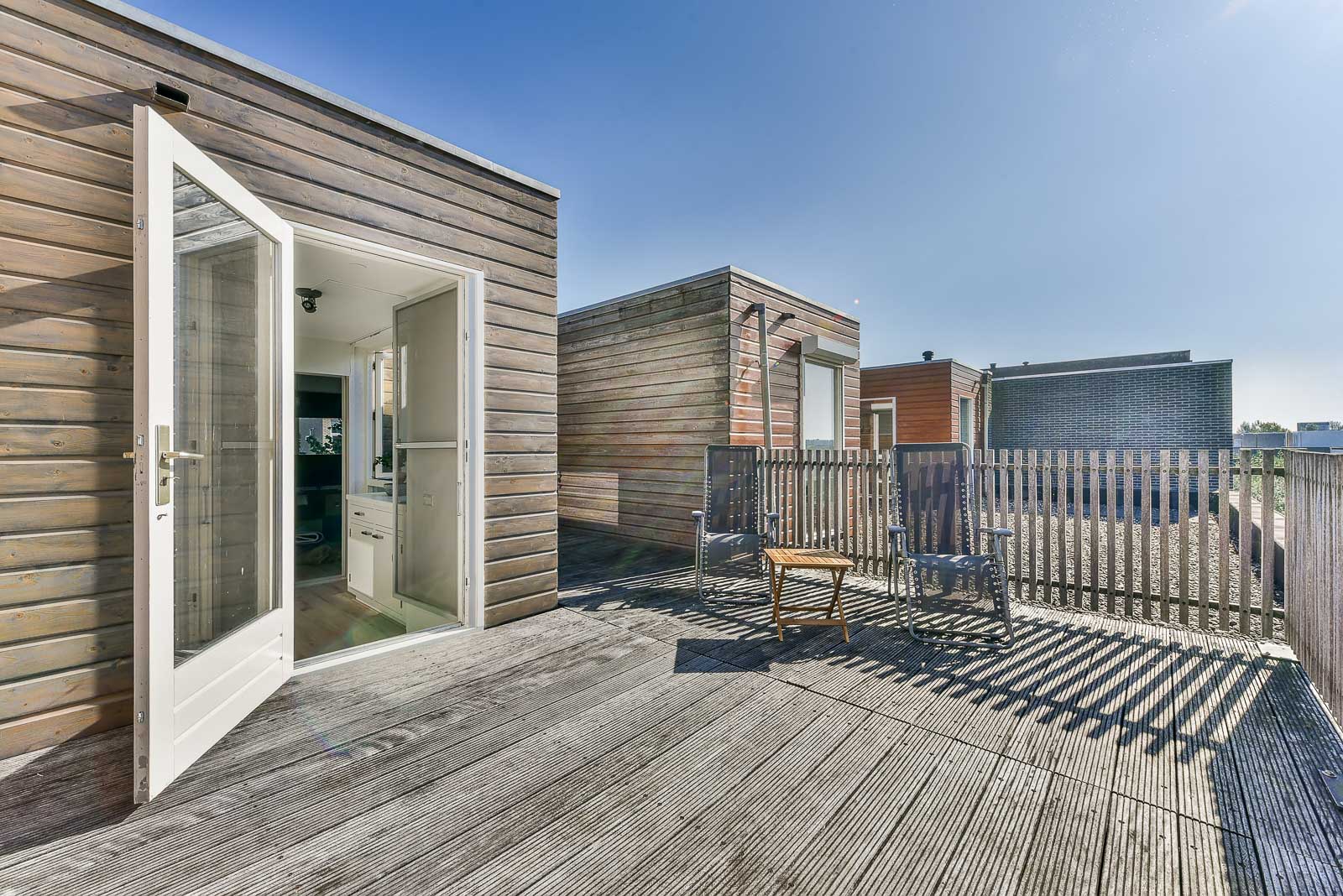 Modular home with glass doors opening onto a wood deck