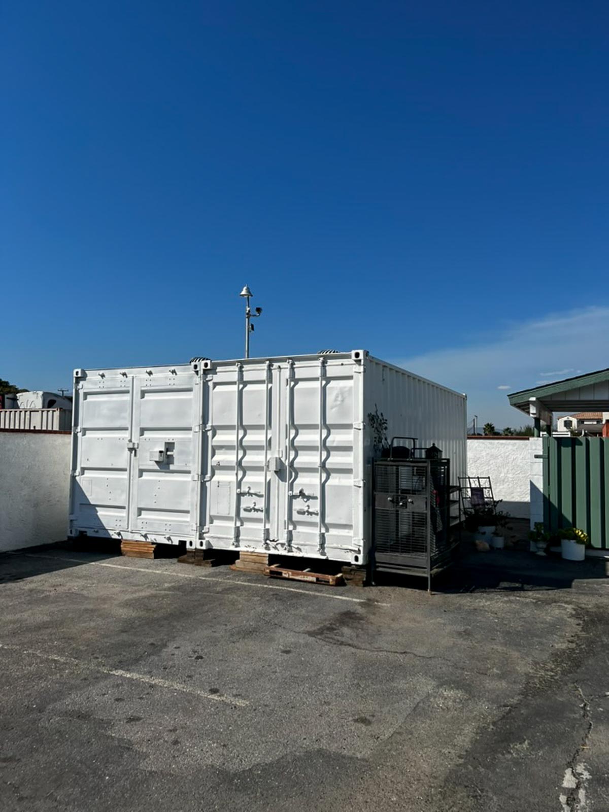 Storage container staged beside modular buildings