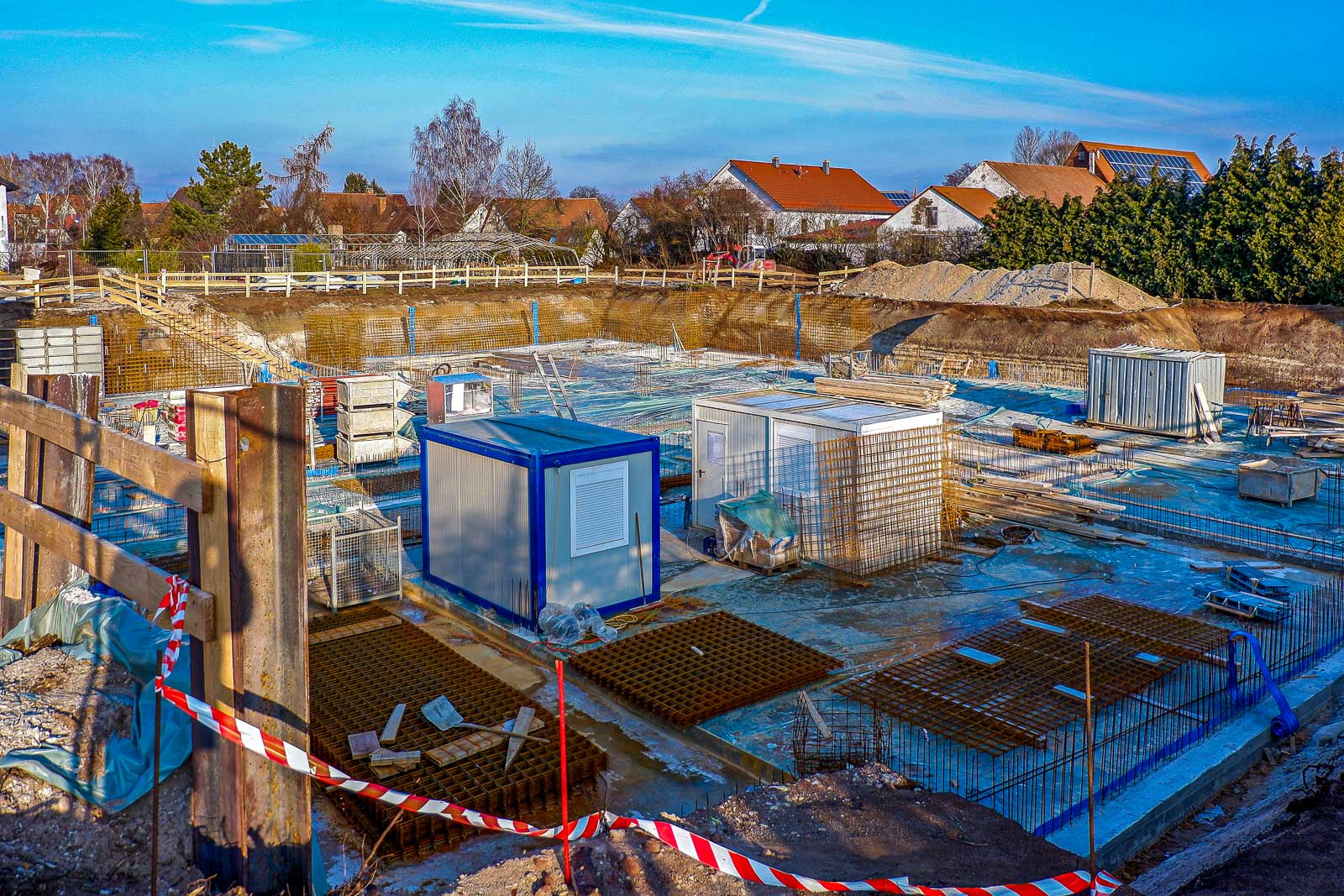 Construction site with formed foundations and modular units being placed