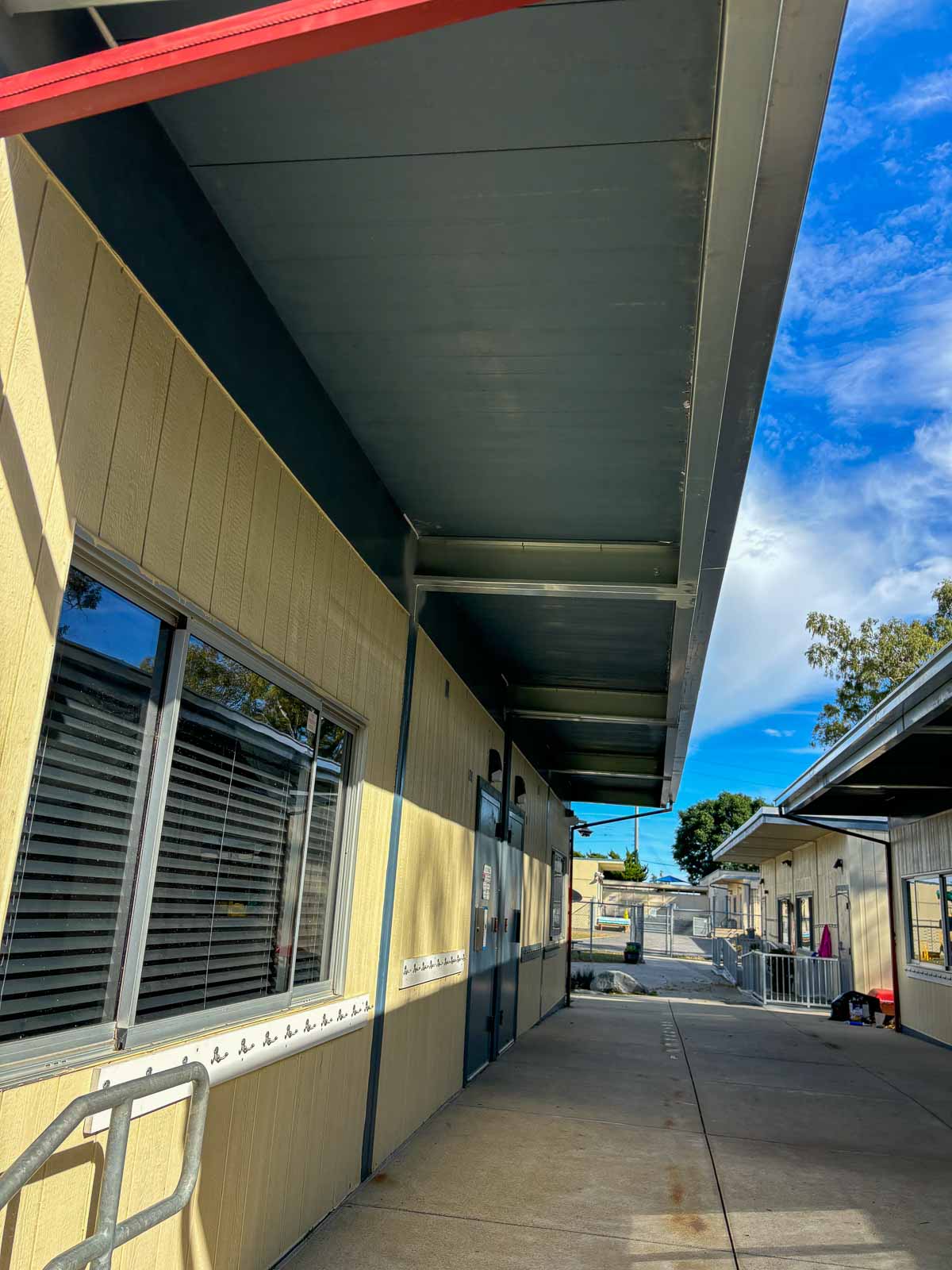 After: finished roofline and repainted trim on a modular classroom